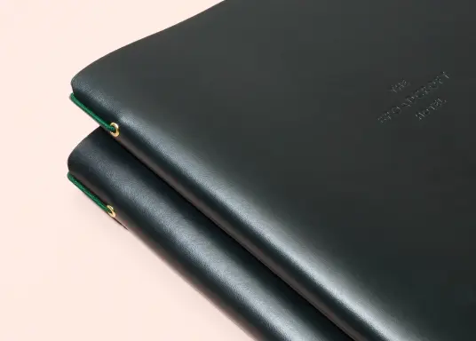 Leather menus for London restaurant on Mount Street, bespoke binding device to aid daily menu updates