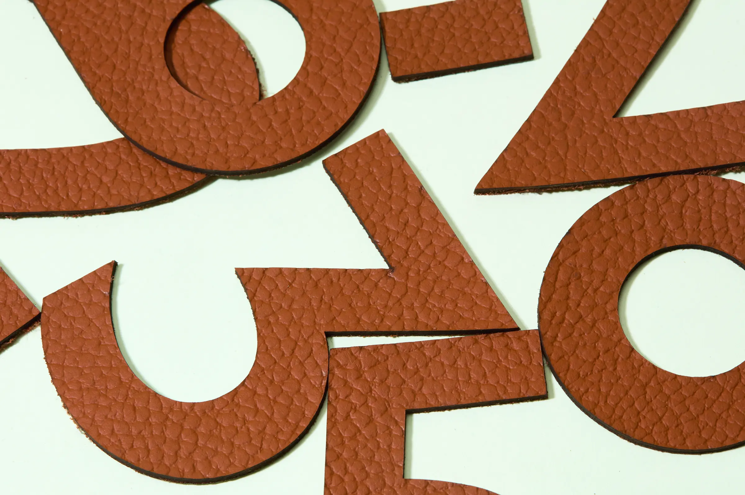 Laser cut numbers using Connolly leather for bespoke signage for an architect.