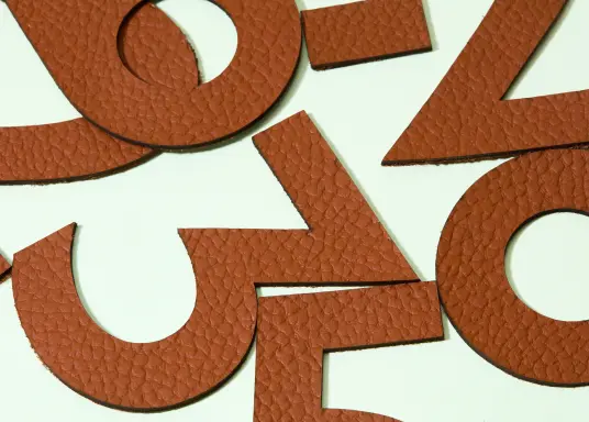 Laser cut numbers using Connolly leather for bespoke signage for an architect.